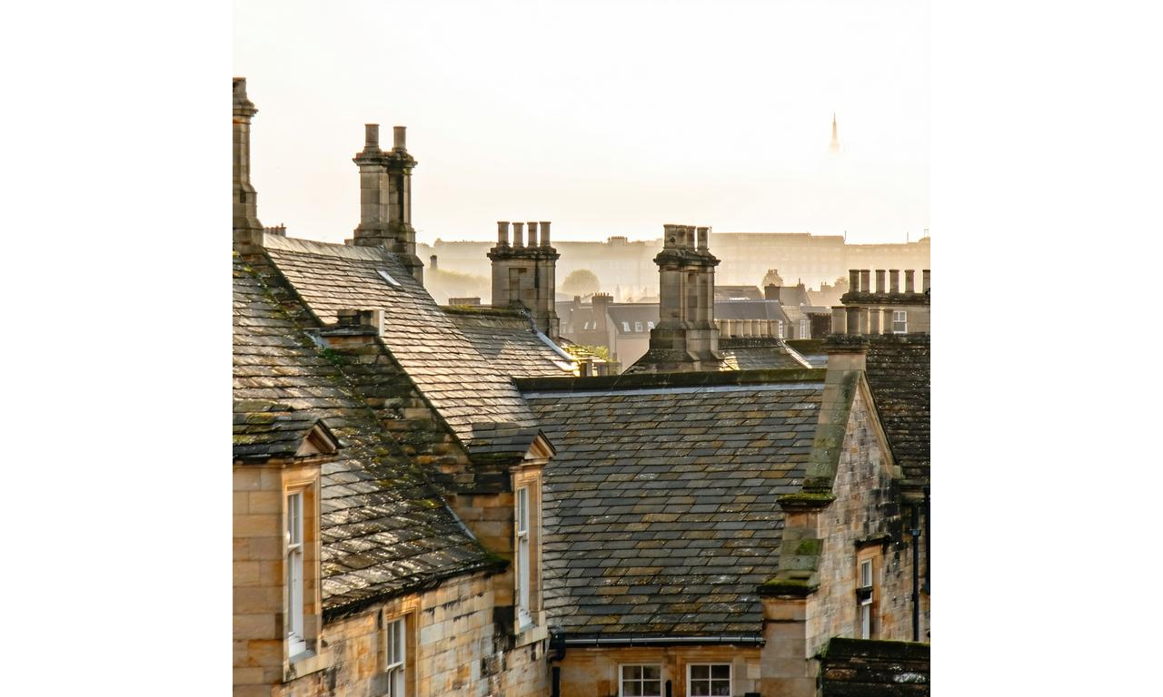 View over historic slate rooftops of Bath at sunset
