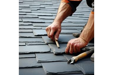 Craftsman replacing damaged slate tiles